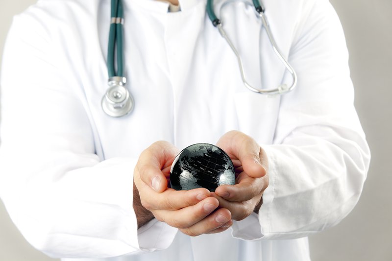 picture of physician with small ball resembling the world