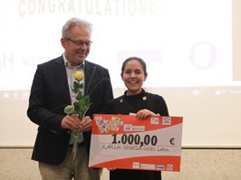 student receives cheque from speaker of the program