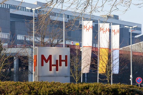 MHH main entrance with metal stele and flagpoles. 