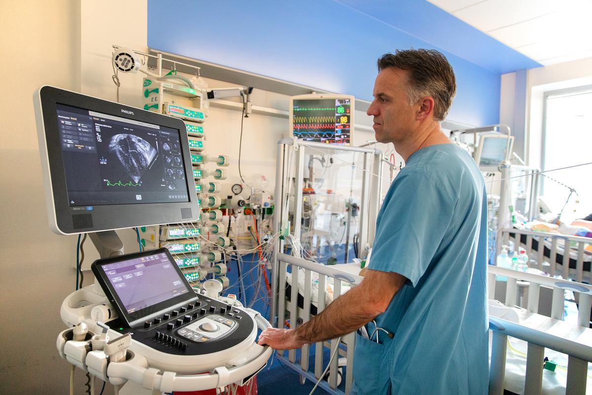A doctor stands in front of an ultrasound machine in the MHH paediatric clinic.